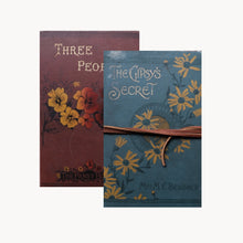 Two vintage-style books with floral designs on their covers.