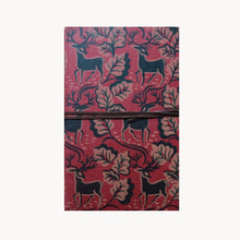 Notebook with deer and leaf pattern on red background