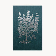 Teal book with white plant design on a white background