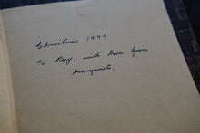 Handwritten text on a beige paper with a blurred background