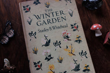 Book titled 'The Winter Garden' by Stanley B. Whitehead with decorative cover on a wooden surface.
