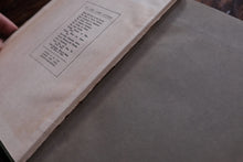 Close-up of an open book with text on a wooden surface