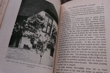 Open book with a black and white photograph of a cottage with a tree in front, and text on the right side.