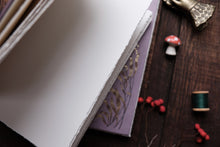 Close-up of a book with decorative elements on a wooden surface