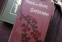 Book titled 'Town and Home Gardening' with a floral design on a wooden surface