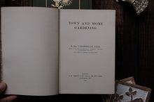 Open book titled 'Town and Home Gardening' on a wooden surface.