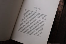 Open book with text on a wooden surface