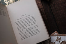 Open book with text on a wooden surface