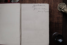 Open book with handwritten text on a wooden surface