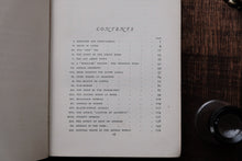 Table of contents page of a book with a wooden surface and metal object in the background