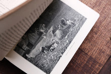Open book with a black and white photograph of a dog on a wooden surface