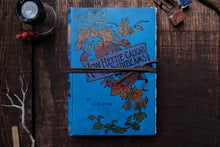 Blue book with decorative cover on a wooden surface