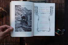 Open book with a black and white photo and text on a wooden surface