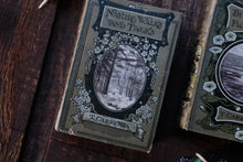 Vintage books with decorative covers on a wooden surface