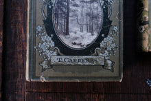 Vintage book with 'T. Carreras' on a wooden surface