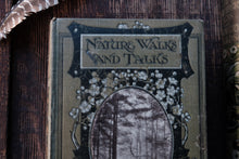 Book titled 'Nature Walks and Talks' with decorative cover on a wooden surface
