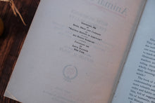 Open book with text and a visible copyright notice on a wooden surface