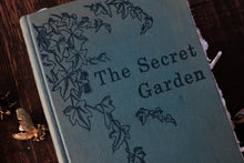 Book titled 'The Secret Garden' with decorative cover on a wooden surface