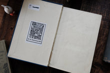 Vintage book with a decorative title page on a wooden surface