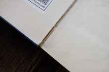 Close-up of a book corner with a visible barcode on a wooden surface.