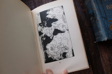 Open book with a black and white illustration on a wooden surface