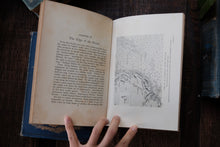 Open book with a black and white illustration and text on a wooden surface