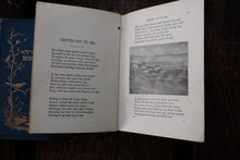 Open book with text and a small illustration on a dark surface
