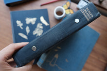 A hand holds a vintage hardcover book titled 'World's Greatest Literature' by John G. A.