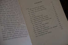 Open book to table of contents page.